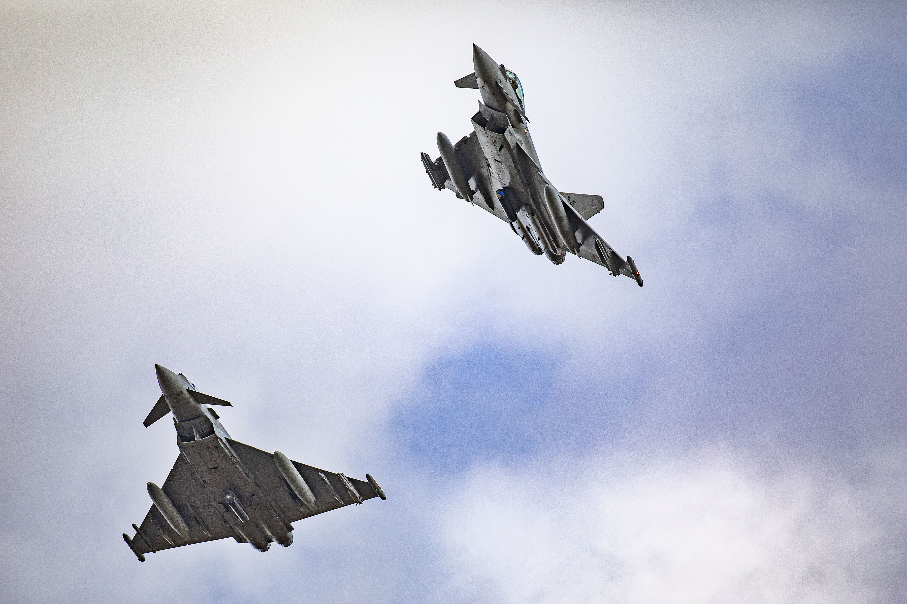 Image shows fighter jets in flight from below.